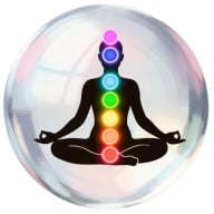 Silhouette of person meditating with chakras