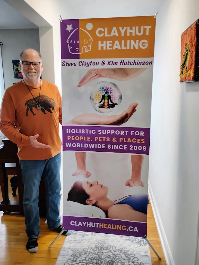Steve standing next to our Clayhut banner