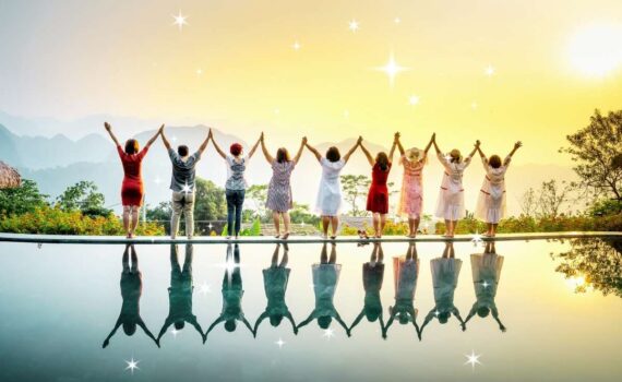 People standing in a row with their hands above their heads