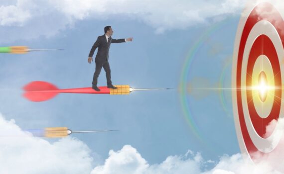 A man riding a dart aiming for the bullseye on the target