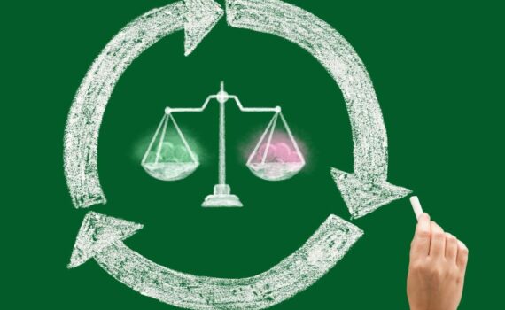 A chalk drawing of a balanced scale inside a circle with arrows showing the cycle of lives