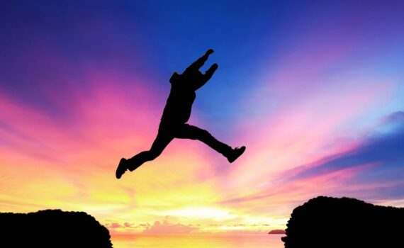 Illustration of a person taking a big leap of faith from one side of a cliff to another